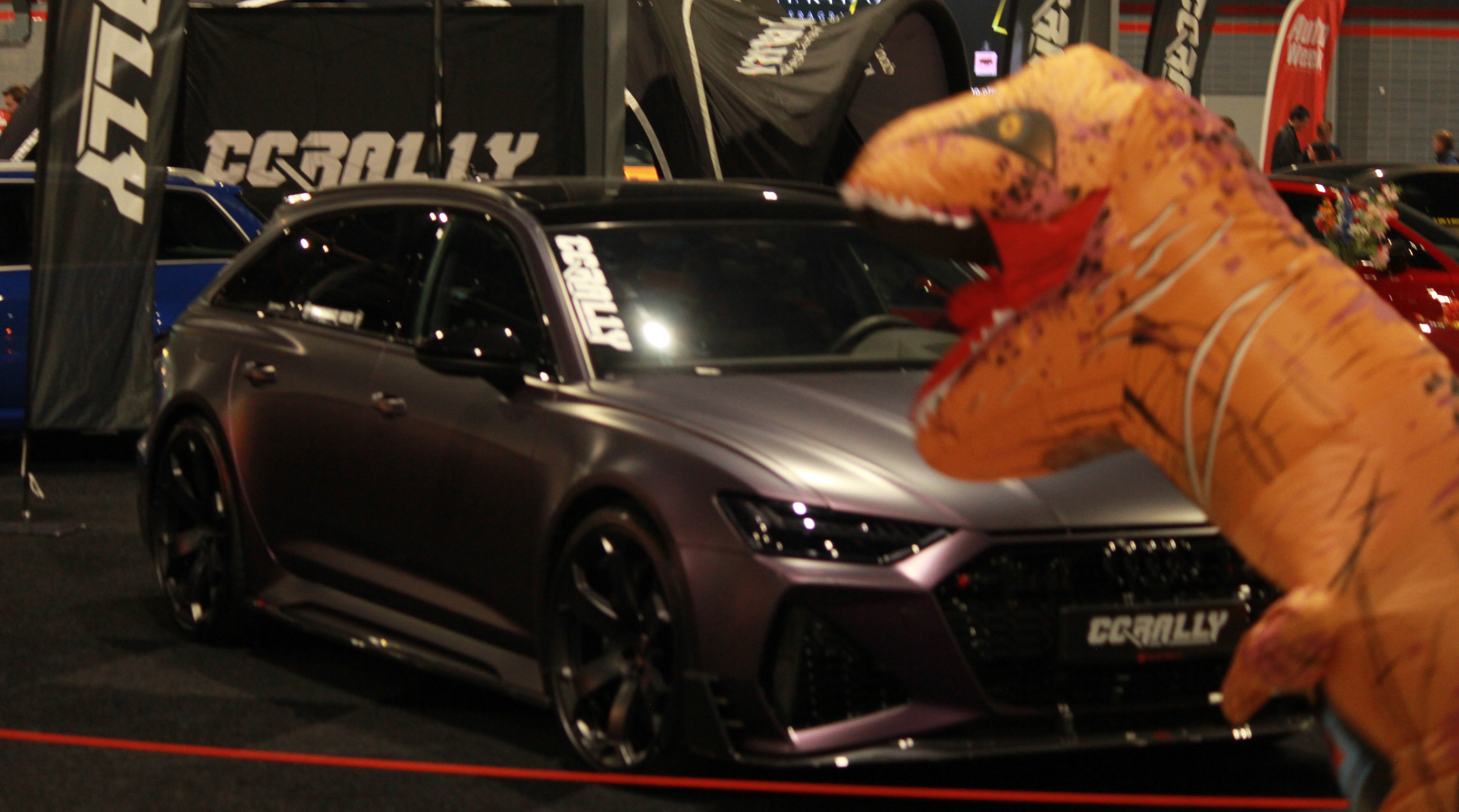 The RS6 and a dinosaur pose together in a surreal mash-up of speed and raw nature.