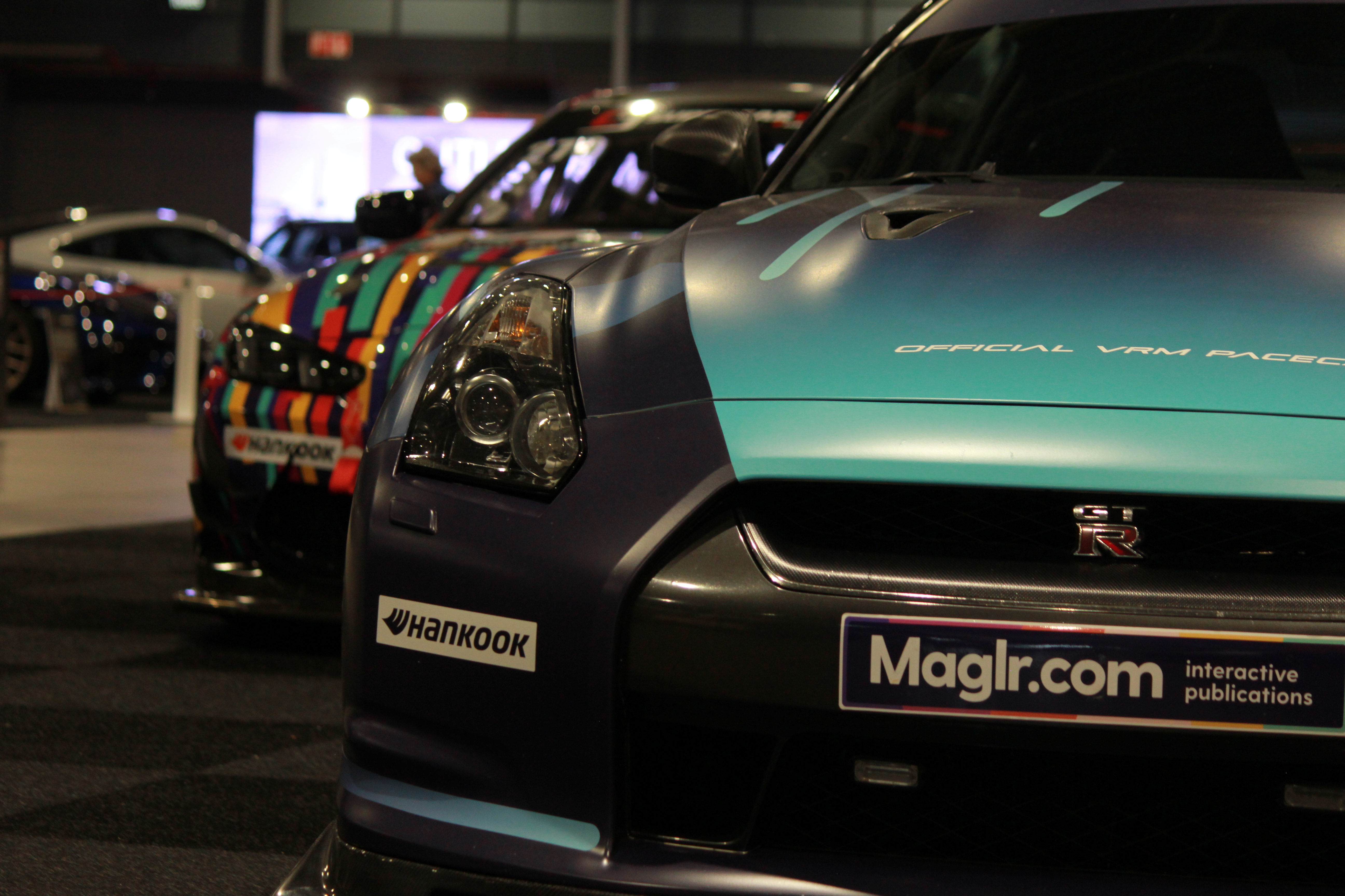 Nissan GTR front with vibrant BMW in background